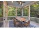 Relaxing screened porch with a wooden dining table, ideal for outdoor entertaining at 2911 Old Tavern Ct, Mount Pleasant, SC 29466
