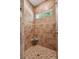 Tiled shower with mosaic accents, bench, window, and bronze fixtures offering a spa-like experience at 2911 Old Tavern Ct, Mount Pleasant, SC 29466