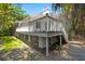 Exterior view of the raised backyard deck with stairs leading to the yard at 3 Sand Dollar Dr, Isle of Palms, SC 29451
