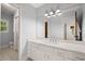 Bathroom featuring a white vanity with undermount sink and a large mirror at 3 Sand Dollar Dr, Isle of Palms, SC 29451