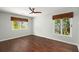 Spacious bedroom features a ceiling fan and two windows with woven shades at 3 Sand Dollar Dr, Isle of Palms, SC 29451