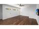 Well-lit bonus room with hardwood floors featuring three windows and a TV at 3 Sand Dollar Dr, Isle of Palms, SC 29451