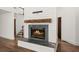 Close-up of the fireplace with a marble surround, wooden mantle, and shiplap accents at 3 Sand Dollar Dr, Isle of Palms, SC 29451