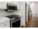 Well-lit kitchen with stainless steel appliances and stone countertops at 3 Sand Dollar Dr, Isle of Palms, SC 29451