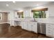 Charming kitchen with white cabinetry, a marble countertop, and hardwood floors at 3 Sand Dollar Dr, Isle of Palms, SC 29451