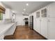 Bright kitchen featuring white cabinets, marble countertops, stainless steel appliances, and hardwood floors at 3 Sand Dollar Dr, Isle of Palms, SC 29451