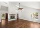 Bright living room featuring hardwood floors, a fireplace, and access to an outdoor space at 3 Sand Dollar Dr, Isle of Palms, SC 29451