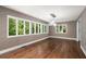 Sitting area featuring hardwood floors, patterned wallpaper and bright natural light coming from multiple windows at 3 Sand Dollar Dr, Isle of Palms, SC 29451