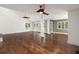 Large open living space with hardwood floors, white walls, ceiling fans and direct balcony access at 3 Sand Dollar Dr, Isle of Palms, SC 29451