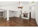 Bright open-concept living room with hardwood floors, fireplace, and stairs leading to the second floor at 3 Sand Dollar Dr, Isle of Palms, SC 29451