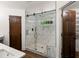 Modern shower with glass door, tile surround, and built-in niche at 3 Sand Dollar Dr, Isle of Palms, SC 29451
