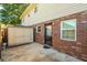 Backyard with shed, wooden fence, brick wall, and door leading into the house at 415 Parkdale Drive # E-8, Charleston, SC 29414