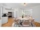 Staged dining area with a modern table and chairs, with a view into the living room and kitchen at 415 Parkdale Drive # E-8, Charleston, SC 29414