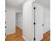 Hallway leading to bedrooms with hardwood flooring and white doors at 415 Parkdale Drive # E-8, Charleston, SC 29414