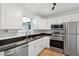 This spacious kitchen features granite countertops, a stainless steel sink, and bright white cabinets at 415 Parkdale Drive # E-8, Charleston, SC 29414