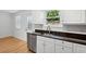 Updated kitchen features a stainless steel dishwasher, modern faucet, and granite countertops at 415 Parkdale Drive # E-8, Charleston, SC 29414