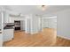 Bright, open kitchen featuring stainless appliances, white cabinets, and hardwood flooring at 415 Parkdale Drive # E-8, Charleston, SC 29414