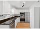 A bright kitchen features white cabinets, granite countertops, and stainless steel appliances at 415 Parkdale Drive # E-8, Charleston, SC 29414