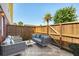 Virtually staged patio with wooden fence and outside furniture with a rug at 415 Parkdale Drive # E-8, Charleston, SC 29414