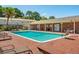 Refreshing community pool surrounded by lounge chairs and a well-maintained brick patio at 415 Parkdale Drive # E-8, Charleston, SC 29414