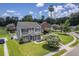 Aerial view of a home with a well-maintained lawn, landscaping, and neighborhood street at 4847 Cane Pole Ln, Summerville, SC 29485