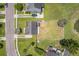 An aerial view shows the property, backyard with white fencing, a pond and mature trees at 4847 Cane Pole Ln, Summerville, SC 29485