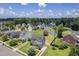 Aerial view of a home with a pond, neighborhood amenities, and lush landscaping at 4847 Cane Pole Ln, Summerville, SC 29485