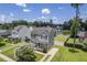 Aerial view of a home with well-manicured landscaping, a pond, and a neighborhood setting at 4847 Cane Pole Ln, Summerville, SC 29485