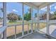 Screened-in back porch overlooking a spacious backyard with views of the neighborhood at 4847 Cane Pole Ln, Summerville, SC 29485