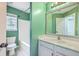Cozy bathroom with green walls, a tub, and a white vanity and mirror combination at 4847 Cane Pole Ln, Summerville, SC 29485