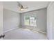 Neutral bedroom featuring carpet, a ceiling fan, and a large window providing natural light at 4847 Cane Pole Ln, Summerville, SC 29485