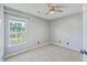 Light-filled bedroom showcasing a window with backyard and pond views, carpet and neutral walls at 4847 Cane Pole Ln, Summerville, SC 29485