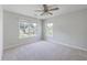 Inviting bedroom with a ceiling fan, neutral carpet, and two windows providing ample natural light at 4847 Cane Pole Ln, Summerville, SC 29485