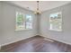 Bright dining room with hardwood floors and two windows at 4847 Cane Pole Ln, Summerville, SC 29485