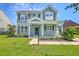 Charming two-story home with a well-manicured lawn and a welcoming front porch at 4847 Cane Pole Ln, Summerville, SC 29485