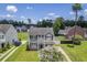 Two-story home boasts manicured lawn, large blooming tree, and well-maintained landscaping at 4847 Cane Pole Ln, Summerville, SC 29485