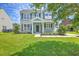 Charming home with a well-manicured lawn, black shutters, and inviting entrance at 4847 Cane Pole Ln, Summerville, SC 29485