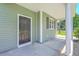 Inviting front porch featuring a black front door, and white columns at 4847 Cane Pole Ln, Summerville, SC 29485