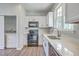 Bright kitchen with white cabinetry, quartz countertops, stainless appliances, and access to the laundry room at 4847 Cane Pole Ln, Summerville, SC 29485