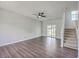 Bright living room with hardwood floors, a ceiling fan, and a sliding glass door to patio at 4847 Cane Pole Ln, Summerville, SC 29485
