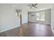 Open-concept living room featuring hardwood floors, a ceiling fan, and a bright window at 4847 Cane Pole Ln, Summerville, SC 29485