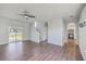 Spacious living room featuring hardwood floors, a ceiling fan, and easy access to the kitchen at 4847 Cane Pole Ln, Summerville, SC 29485
