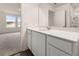 Bathroom featuring white cabinets, solid surface counters, and view into the Primary bedroom at 5005 Ferry Field Dr, Summerville, SC 29485