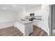 Stylish kitchen with granite countertops, an island, stainless steel appliances, and hardwood floors at 5005 Ferry Field Dr, Summerville, SC 29485