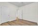 Bedroom with light walls, and laminate wood flooring with doors at 545 Wayton Cir, Moncks Corner, SC 29461