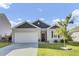 Charming single-story home featuring a two-car garage, well-manicured lawn, and beautiful landscaping at 545 Wayton Cir, Moncks Corner, SC 29461
