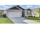 A delightful single-story house with a two-car garage, a pristine lawn, and charming landscaping at 545 Wayton Cir, Moncks Corner, SC 29461
