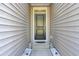Inviting front entrance featuring a stylish black door, modern lighting, and white stone landscaping at 545 Wayton Cir, Moncks Corner, SC 29461