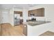 Bright and modern kitchen with stainless steel appliances, wood floors and breakfast bar seating at 545 Wayton Cir, Moncks Corner, SC 29461