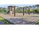 Community playground with swings, slide, climbing wall and wooden tower surrounded by woodchips at 545 Wayton Cir, Moncks Corner, SC 29461